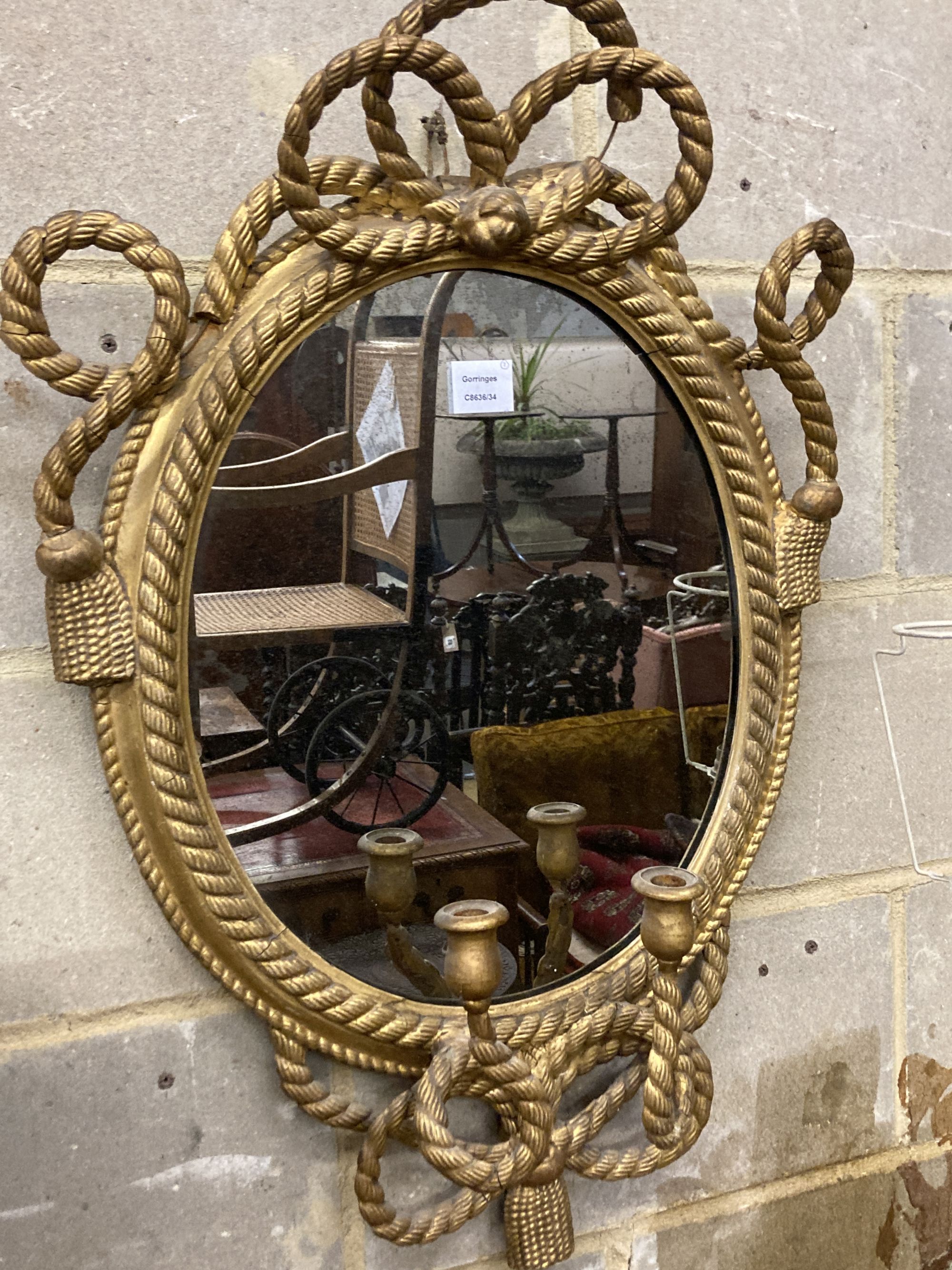 A pair of Victorian gilt wood and gesso oval girandoles, width 52cm, height 82cm